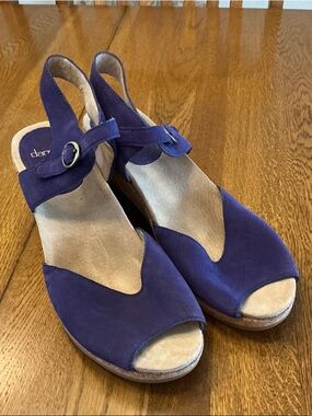 Woman’s Dansko purple wedge sandals. Size 41. Leather uppers. Buckle ankle strap